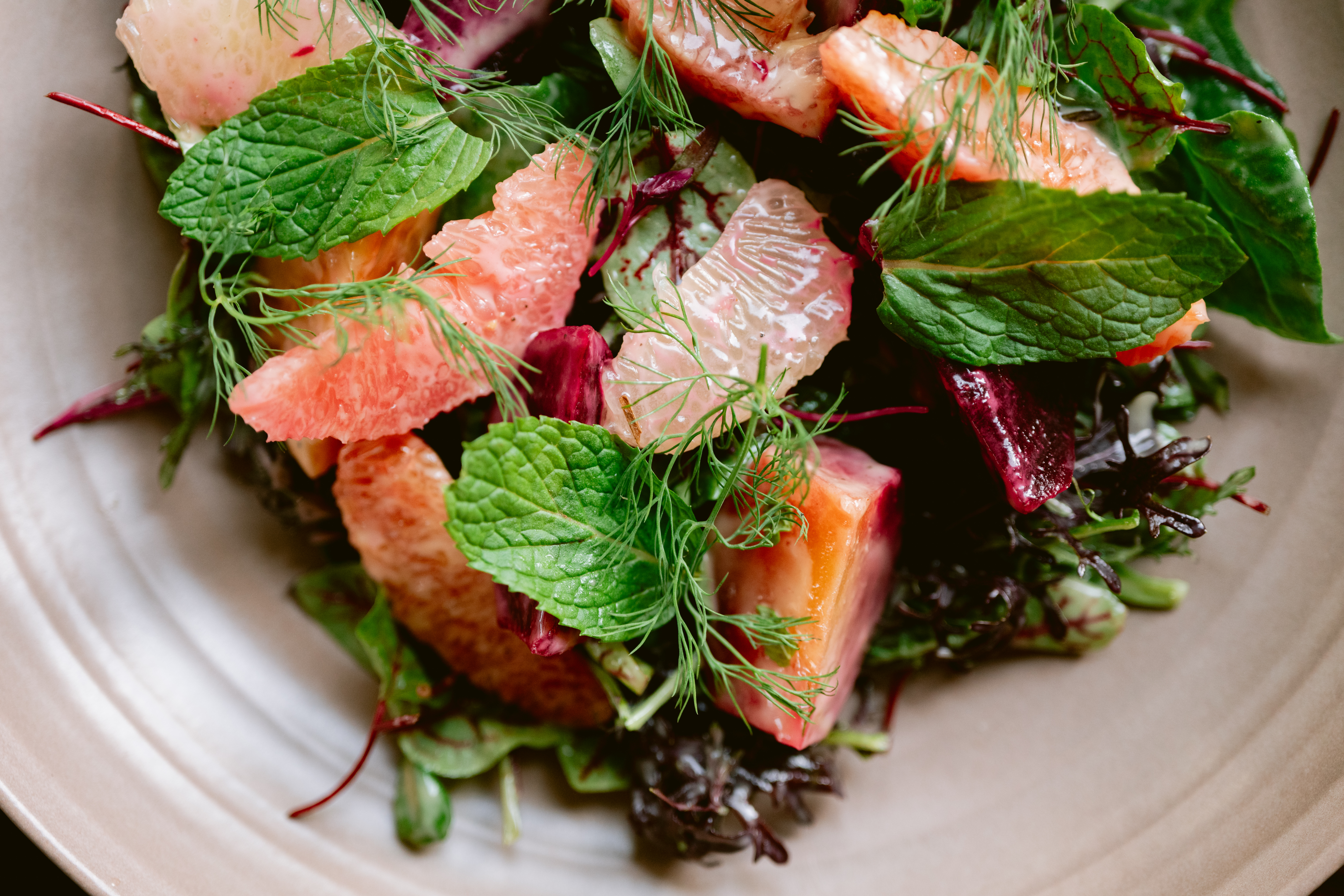 a plate with a sandwich and a salad