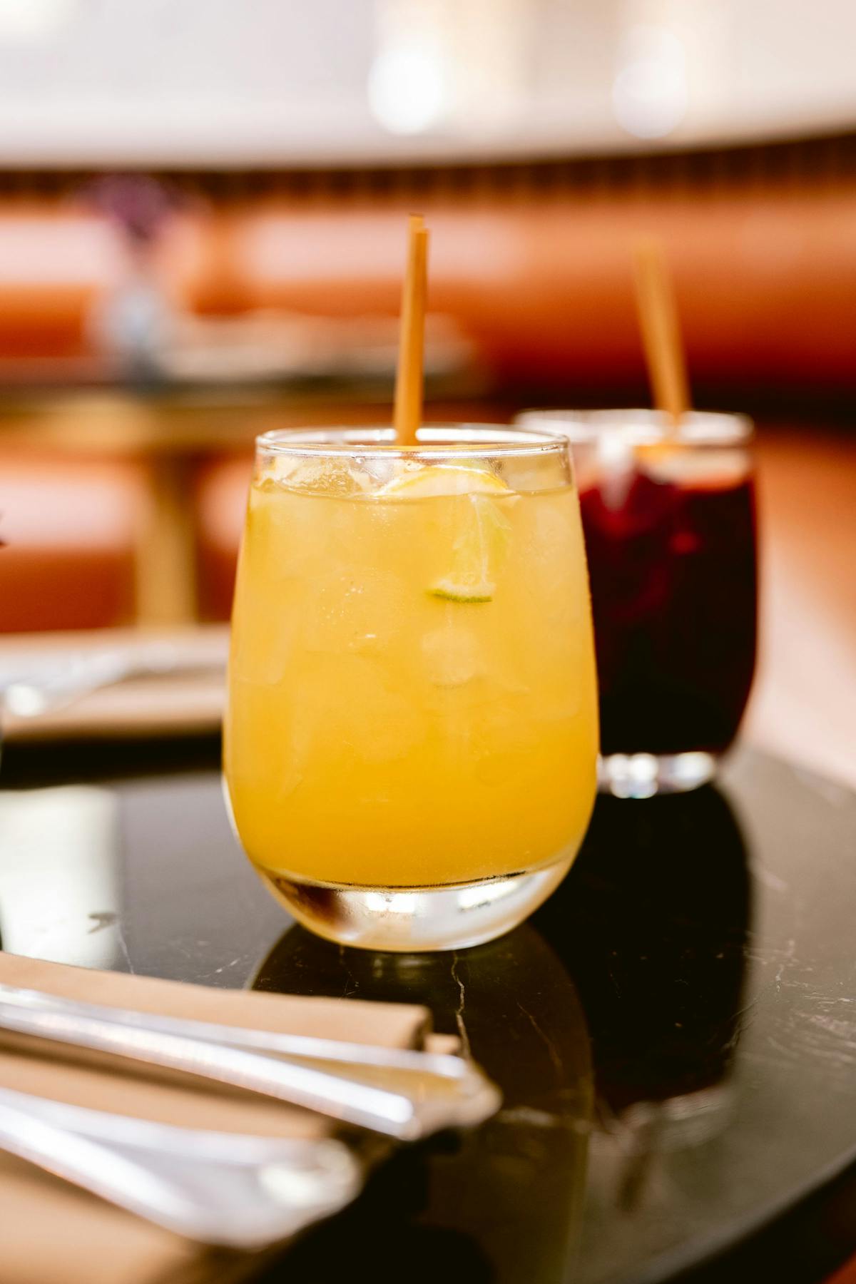 a glass of orange juice on a table
