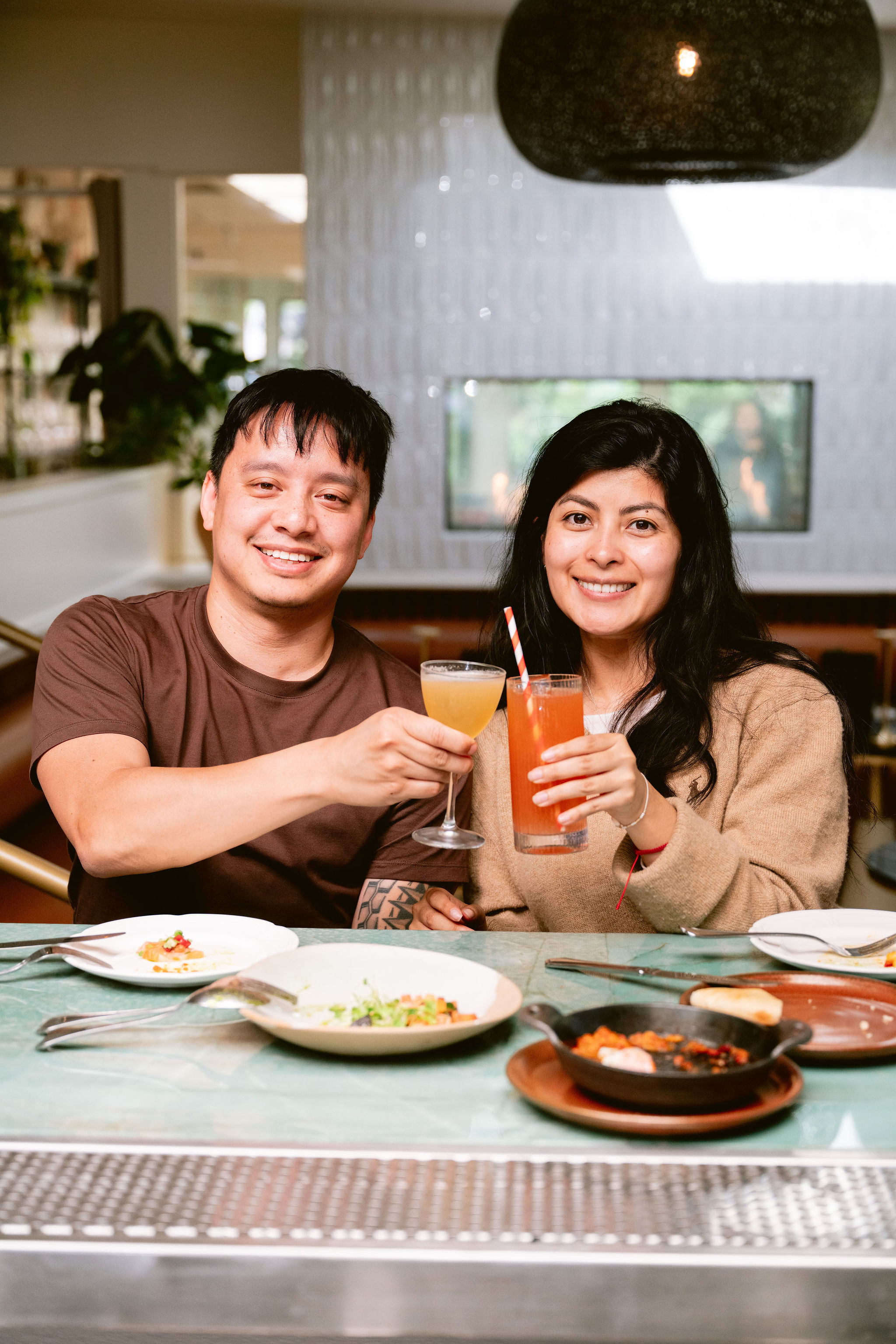 a group of people sitting at a table with food