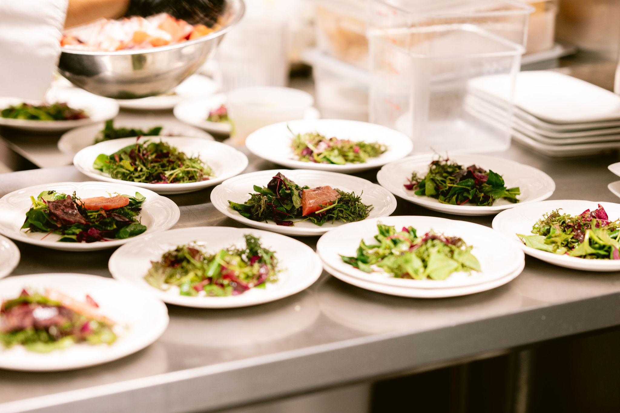 a group of plates of salad on a counter