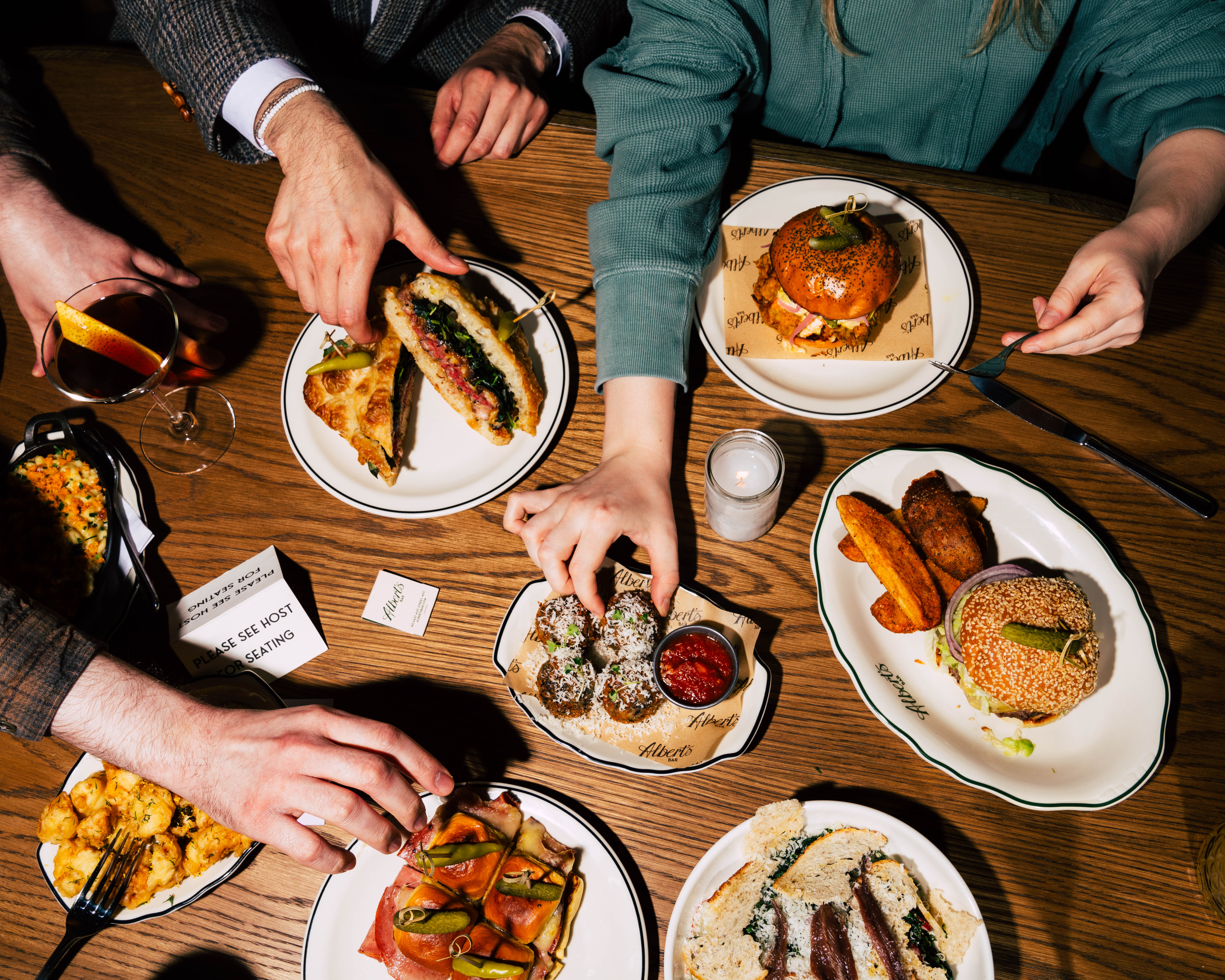 a group of people sitting at a table with a plate of food
