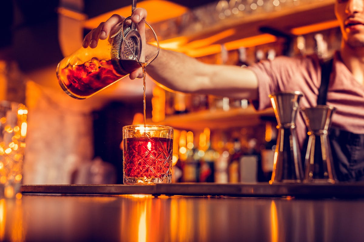 a person standing in front of a bar