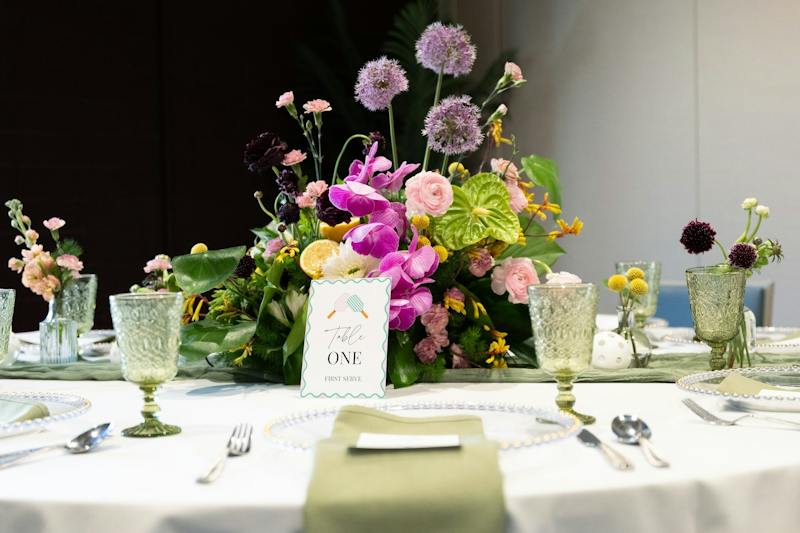 Reception table with flowers and place settings at Dink & Dine Pickle Park