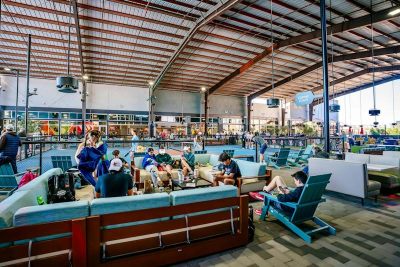 Lounge seating full of guests under the covered Pickle Park at Dink & Dine Pickle Park