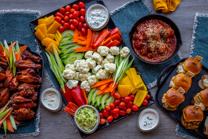 Shareables platter with wings, sliders and fresh vegetables