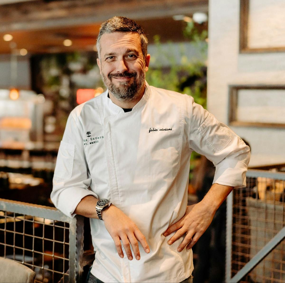 Fabio Viviani standing next to a fence