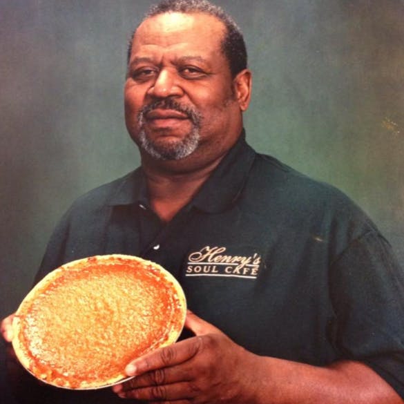 a man holding a glass of orange juice