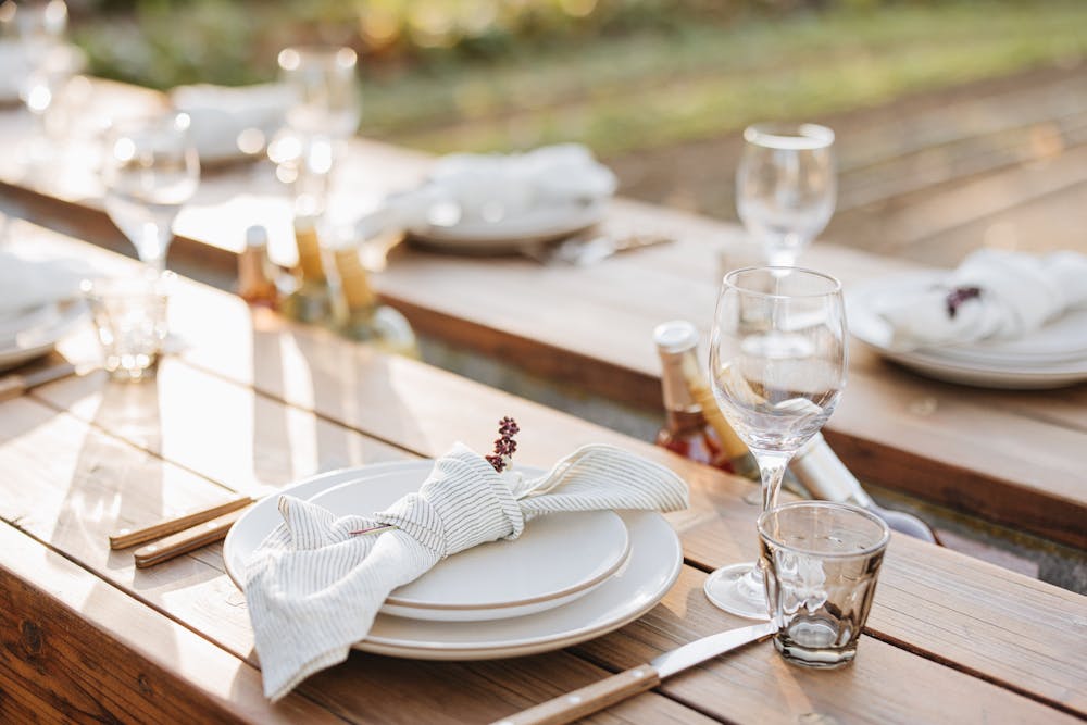 a glass of wine sitting on top of a wooden table