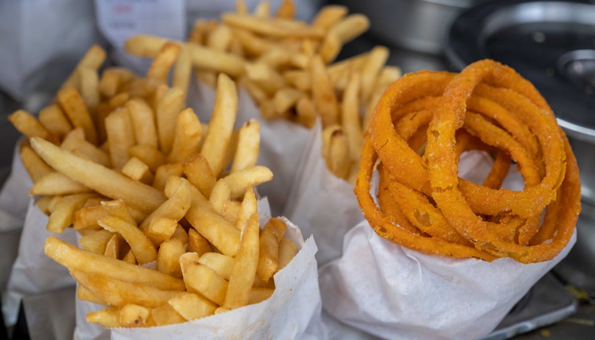 a basket of fries and a hot dog on a bun