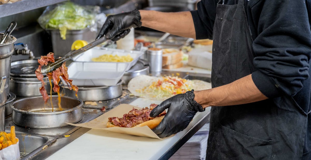 a person cooking in a kitchen preparing food