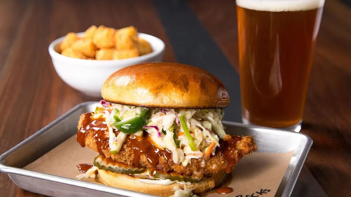 a close up of a sandwich sitting on top of a wooden table
