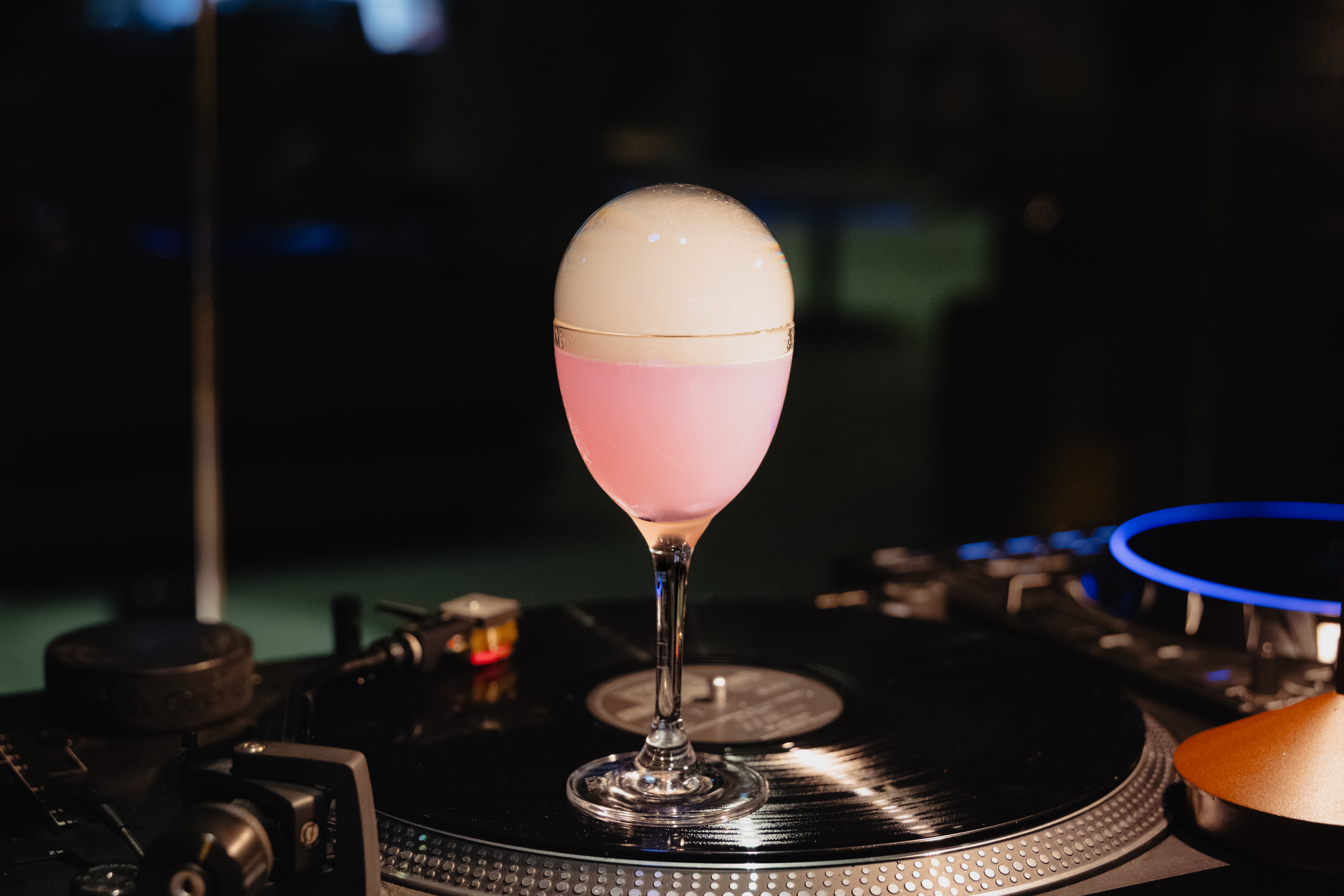 a glass of wine sitting on top of a table