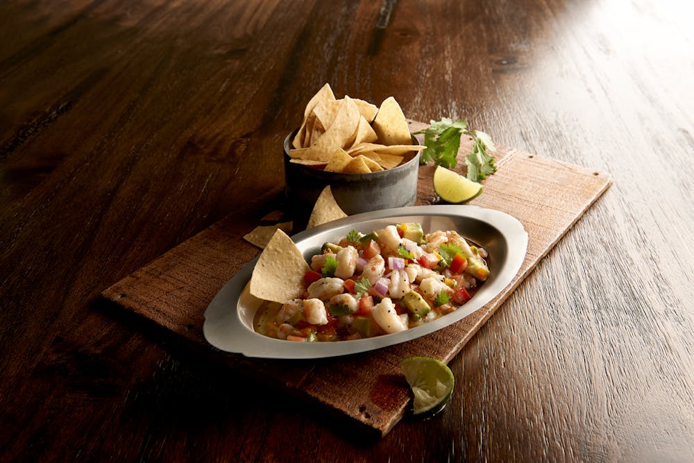 a plate of food sitting on top of a wooden table