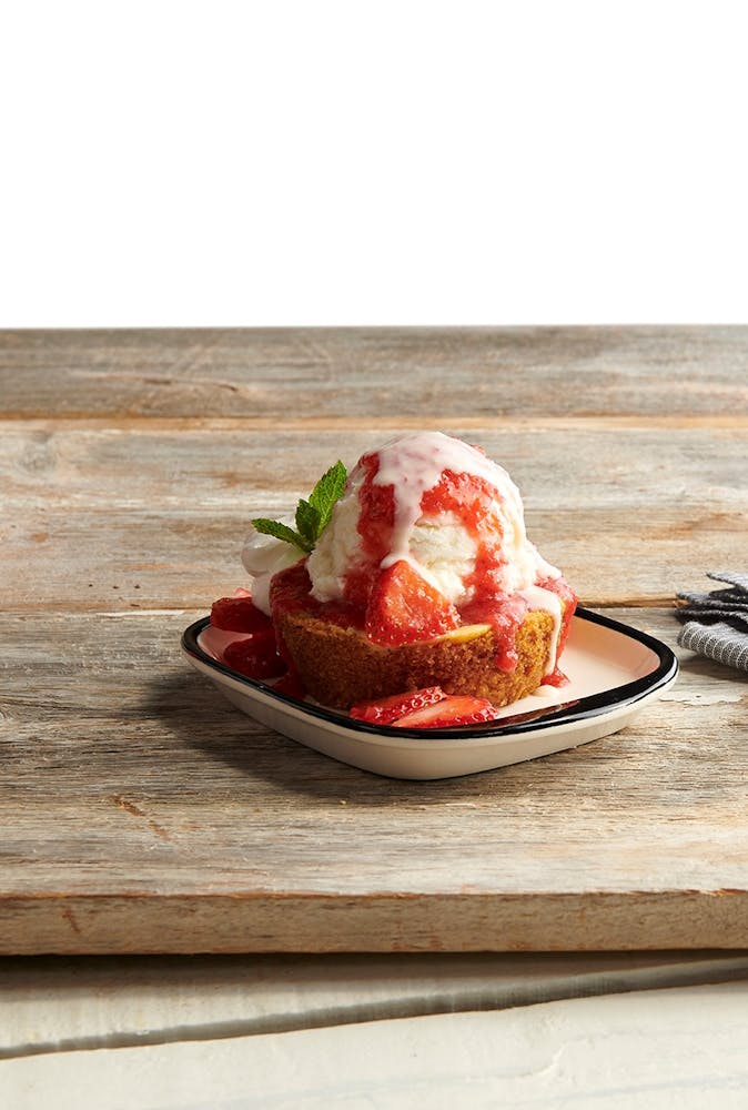 a piece of cake sitting on top of a wooden cutting board