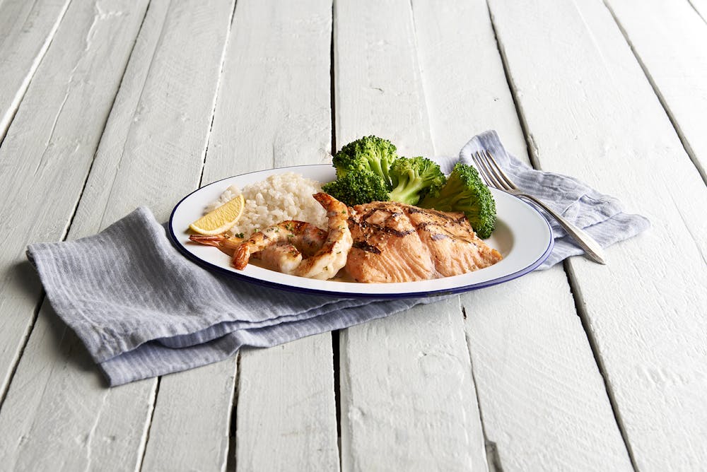 a plate of food sitting on top of a wooden table