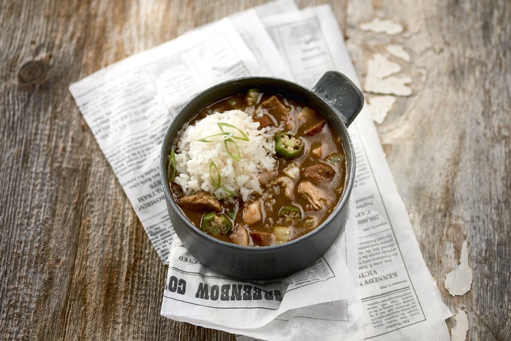 a bowl of food sitting on top of a wooden table