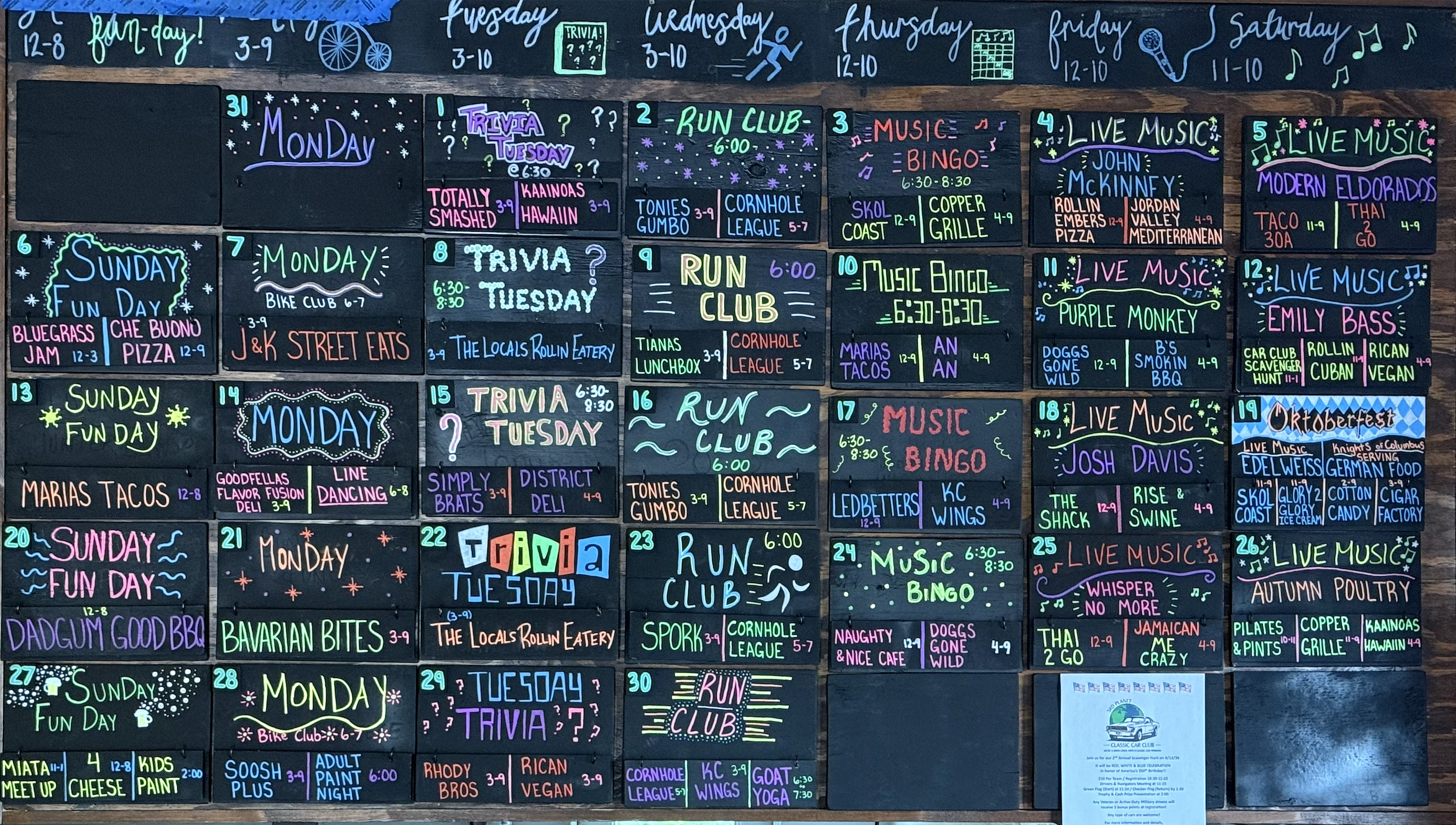 a wall of black signs with writing