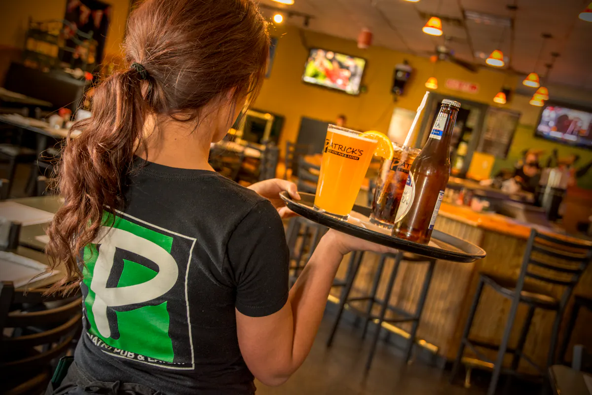 waitress serving an orange juice