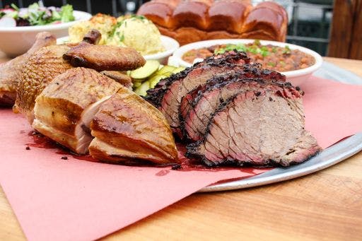 a plate of food sitting on top of a wooden table