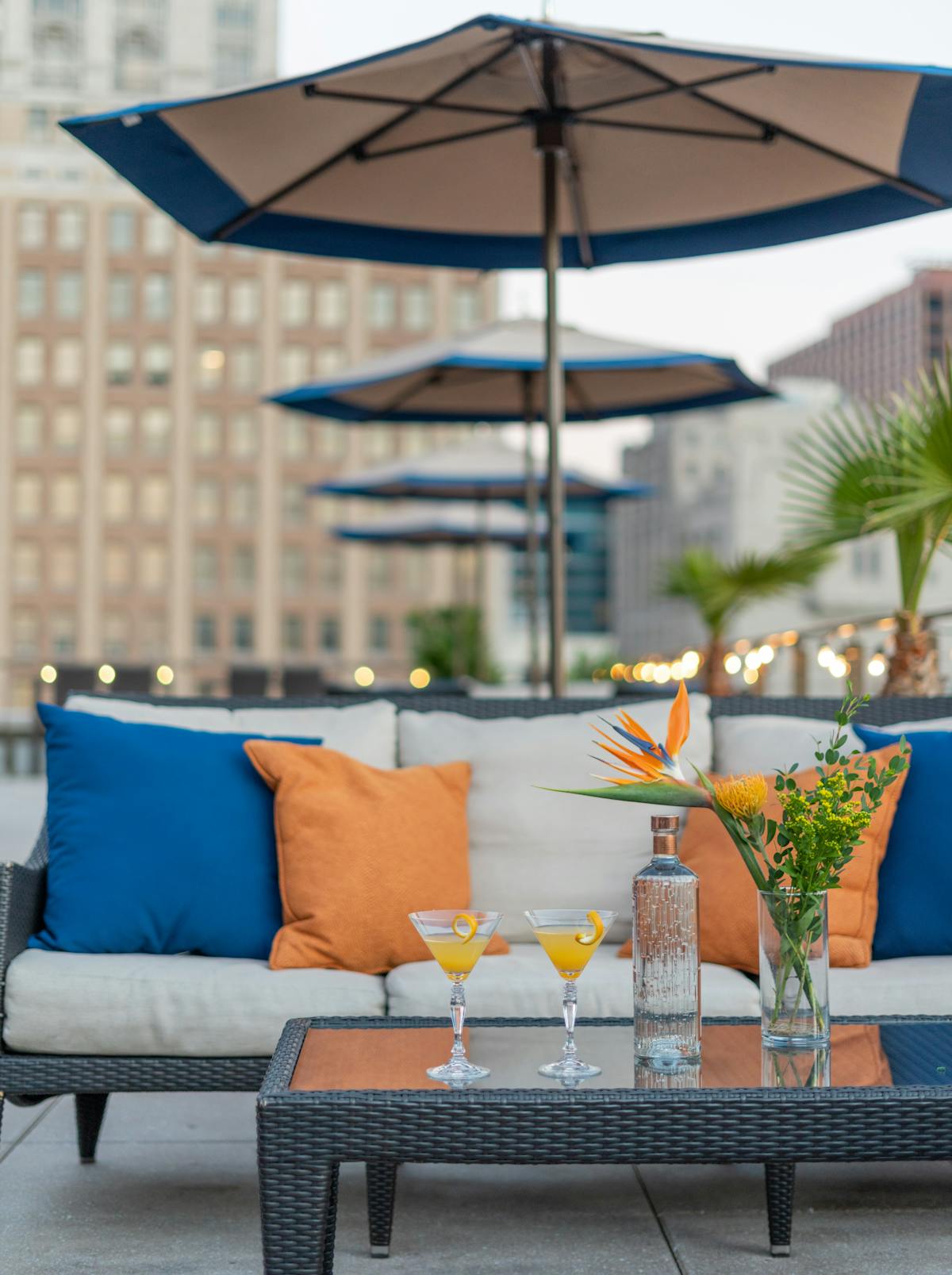 a glass with a blue umbrella sitting on top of a table