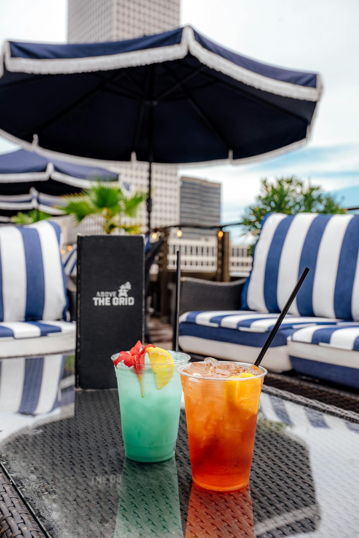 a glass with a blue umbrella sitting on top of a table