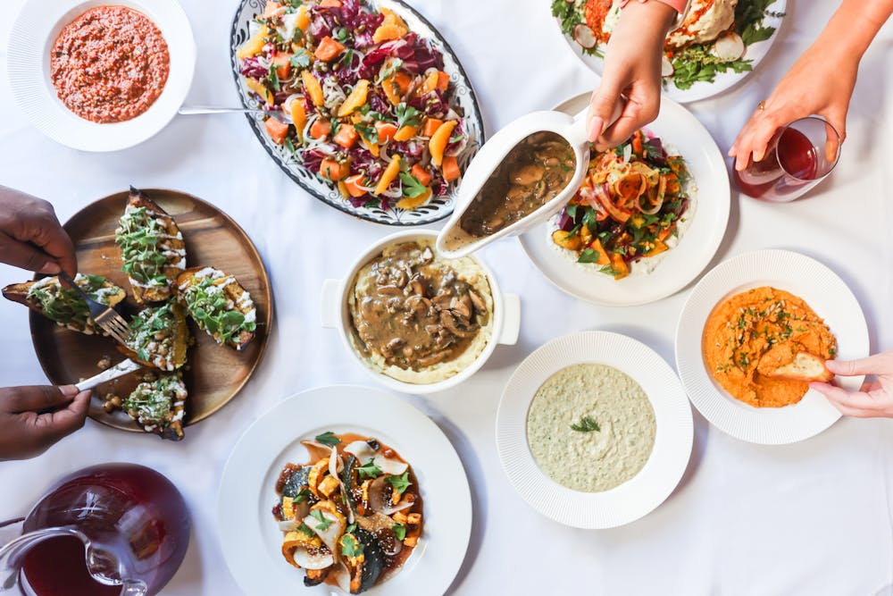 a group of people sitting at a table with a plate of food