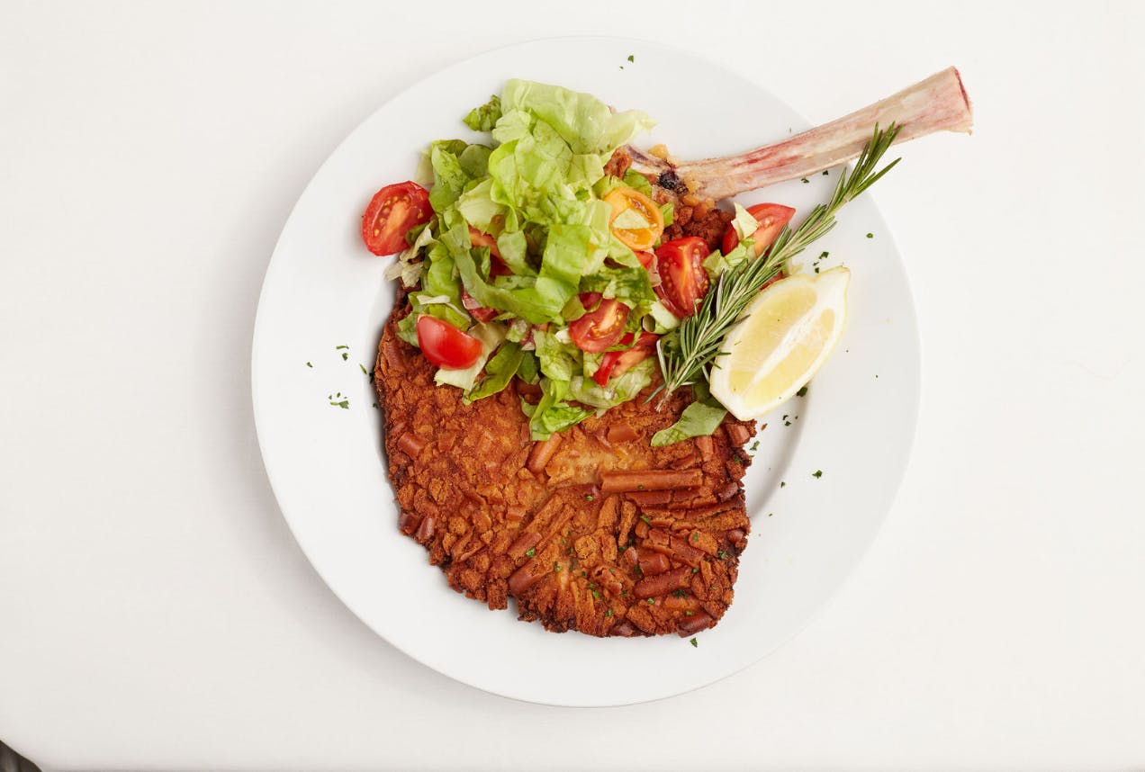a white plate topped with meat and vegetables