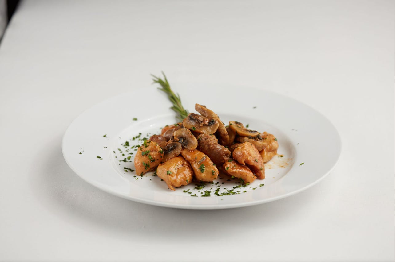 a white plate topped with meat and vegetables