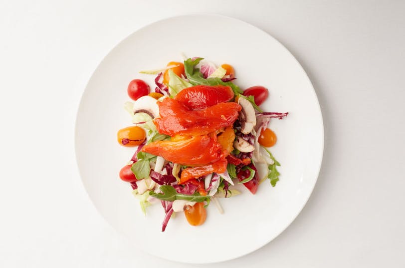 a bowl of salad on a white plate