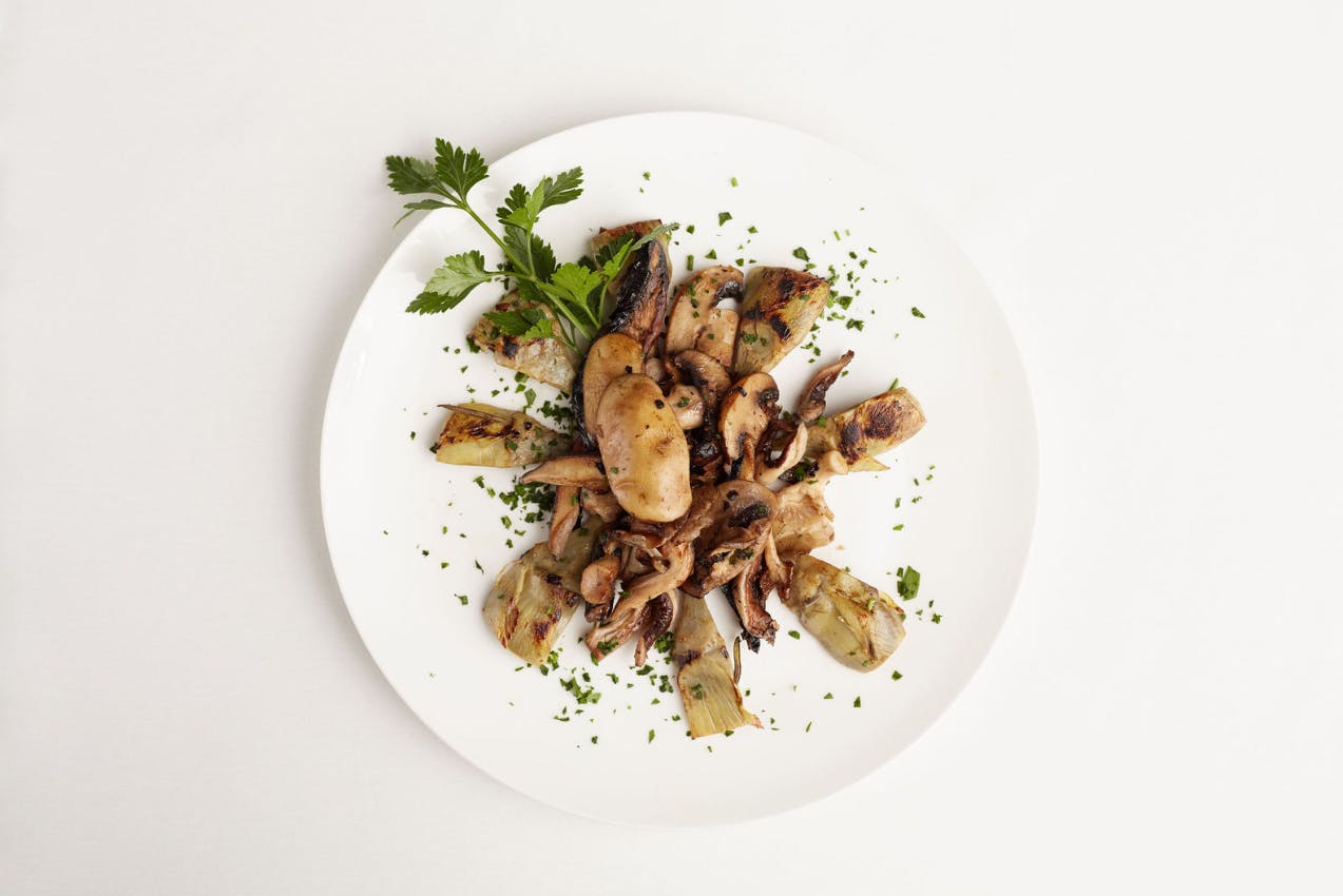 a white plate topped with meat and vegetables