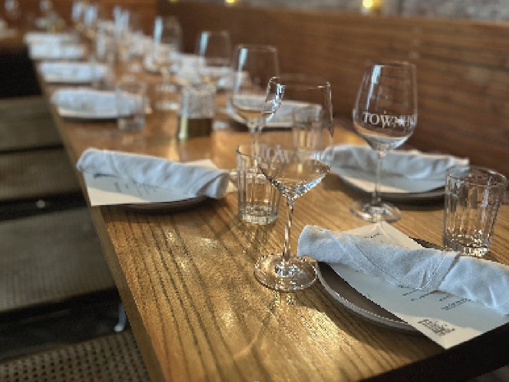 a glass of wine sitting on top of a wooden table