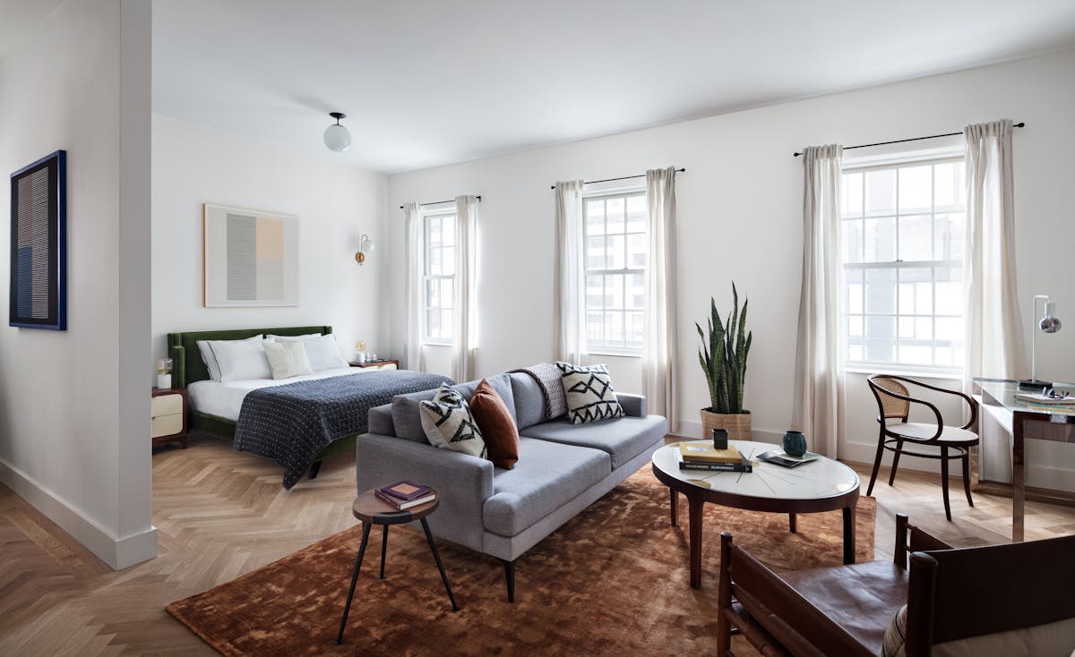 a living room filled with furniture and a large window