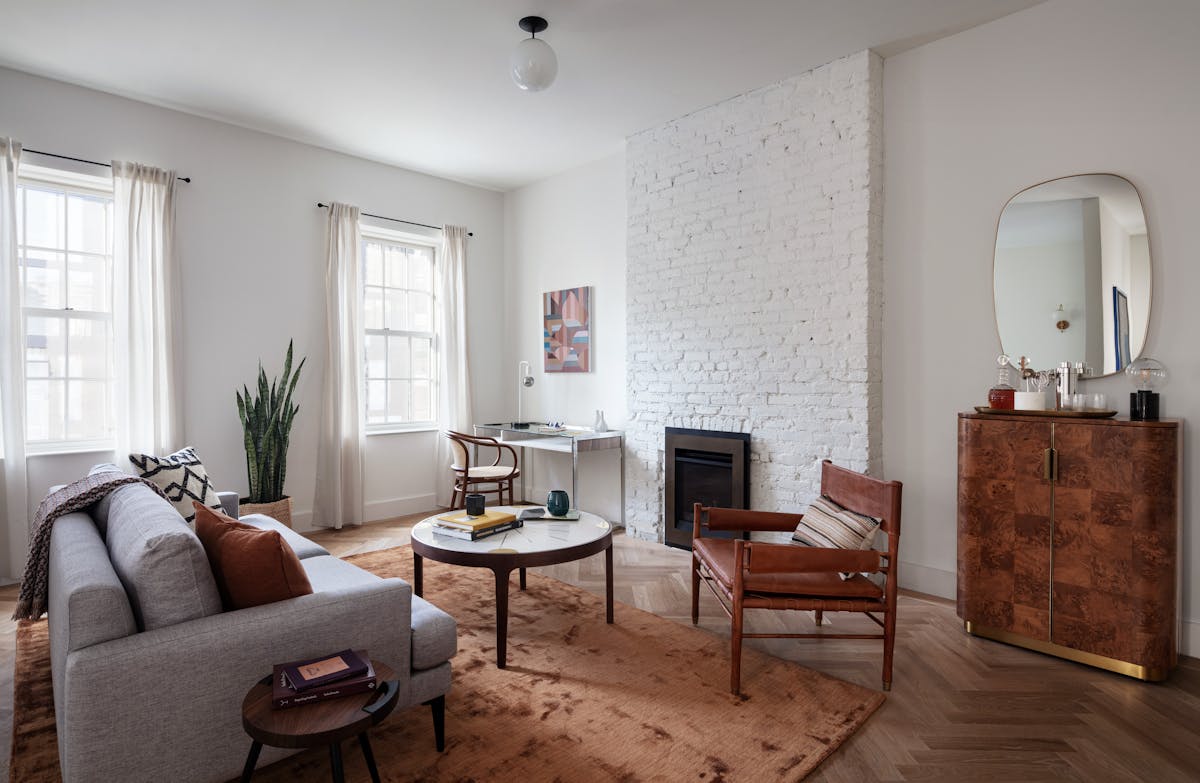 a living room filled with furniture and a large window