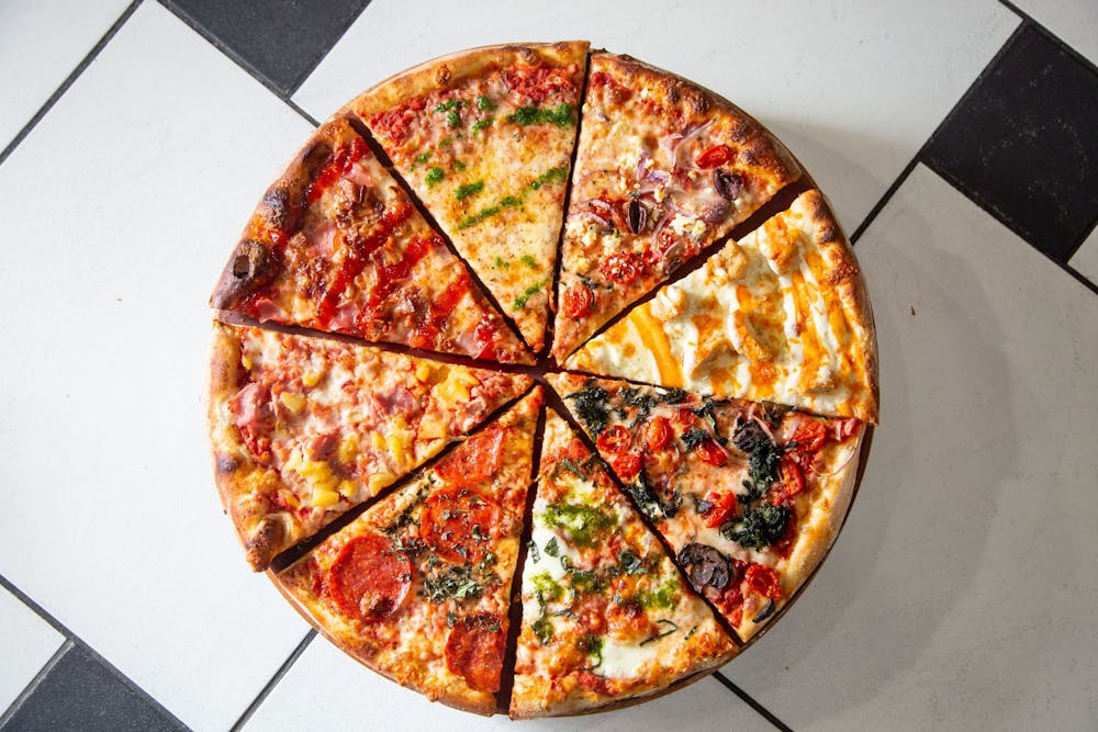 a pizza sitting on top of a wooden cutting board