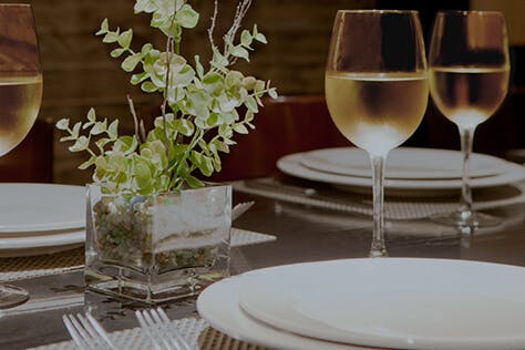 close up of a plate and glass of wine