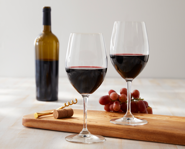 a bottle of wine sitting on top of a wooden table
