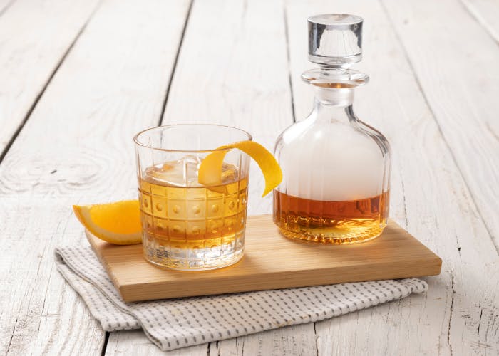 a glass bottle sitting on top of a wooden table