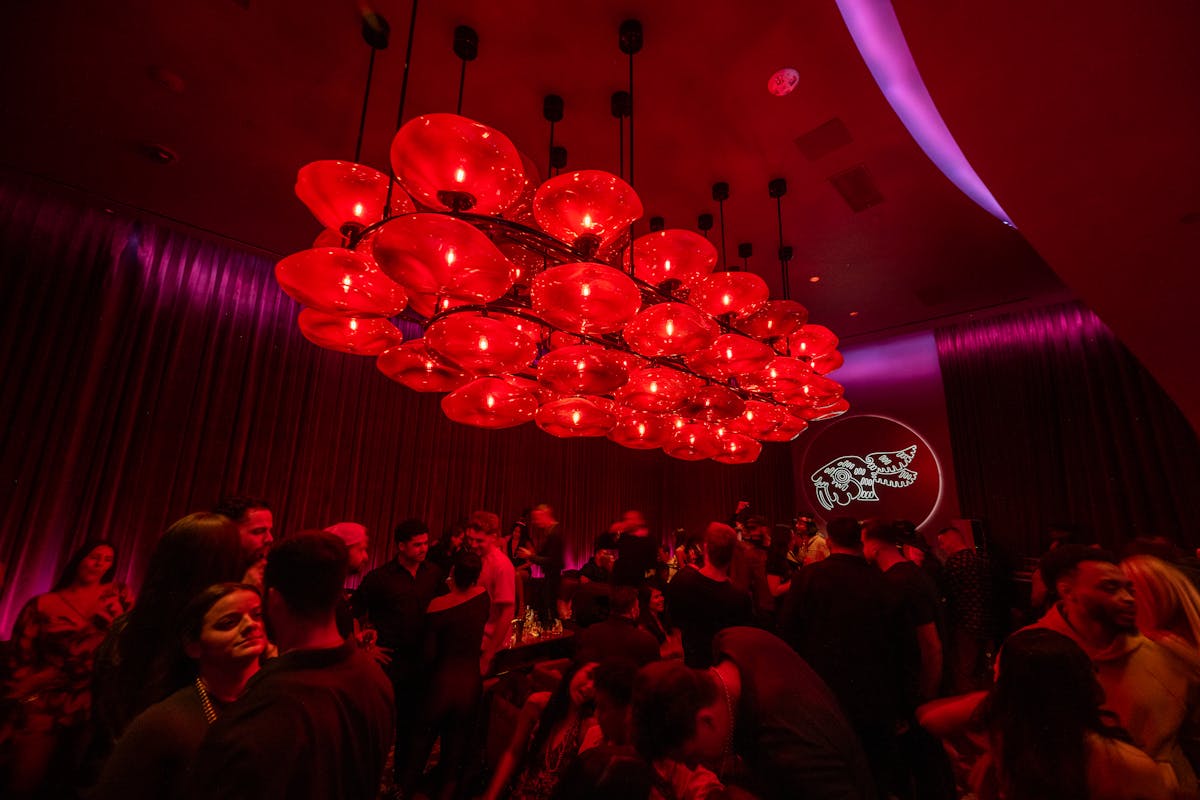 a crowd of people in a dark room