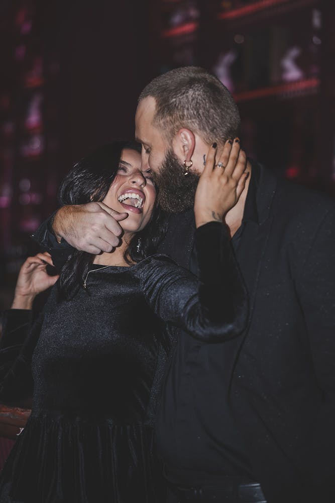 Couple holding each other and smiling for photoshoot.