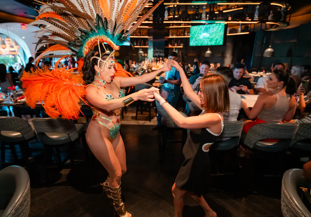 Carnival dancer engaging with guests at Mijo Modern Mexican brunch, a high-energy Las Vegas Mexican restaurant and local Mexican destination for immersive dining and entertainment.