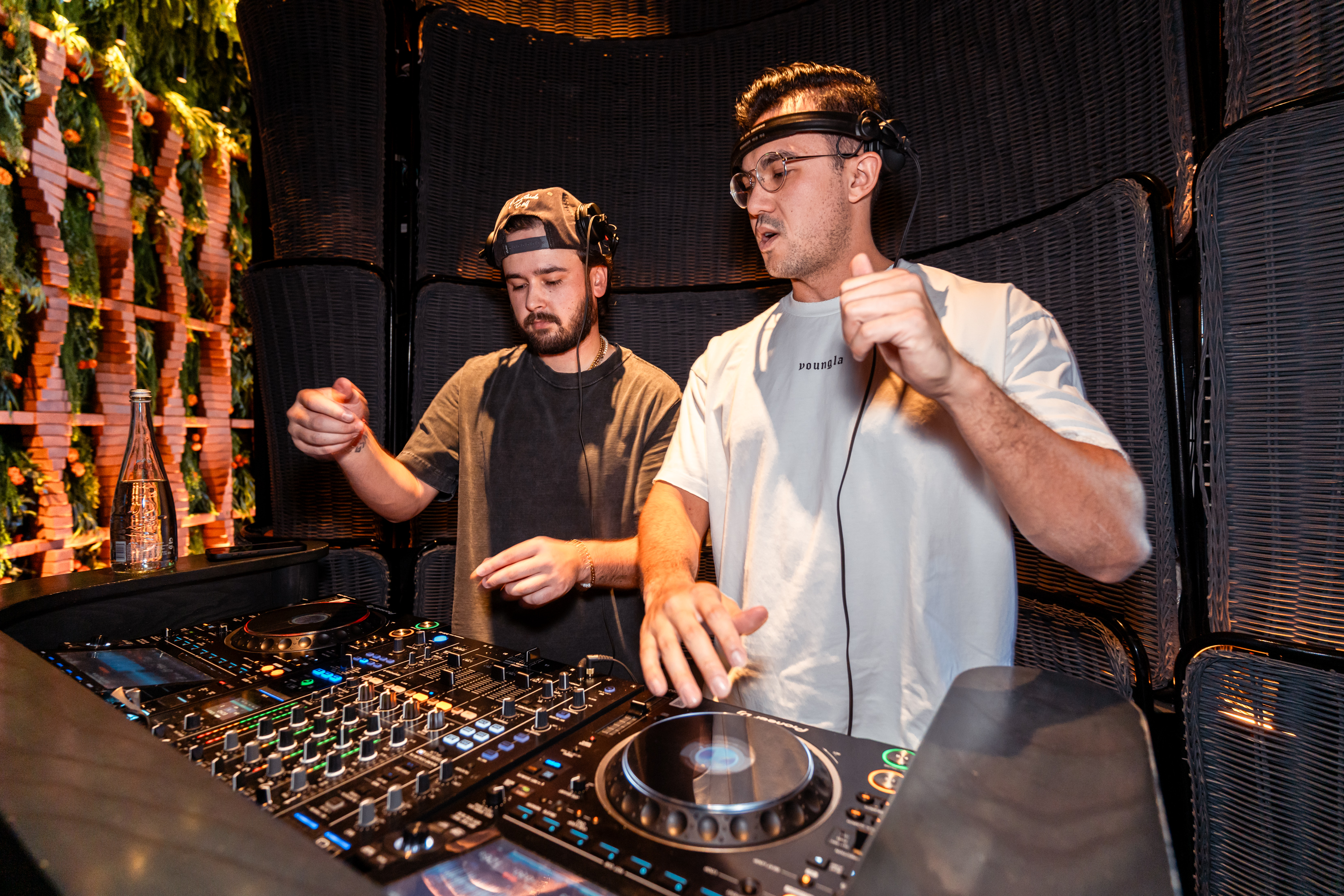 Two DJs performing together at Mijo Modern Mexican spinning live music beside the DJ booth during a vibrant weekend dinner crowd at the Las Vegas Mexican restaurant.
