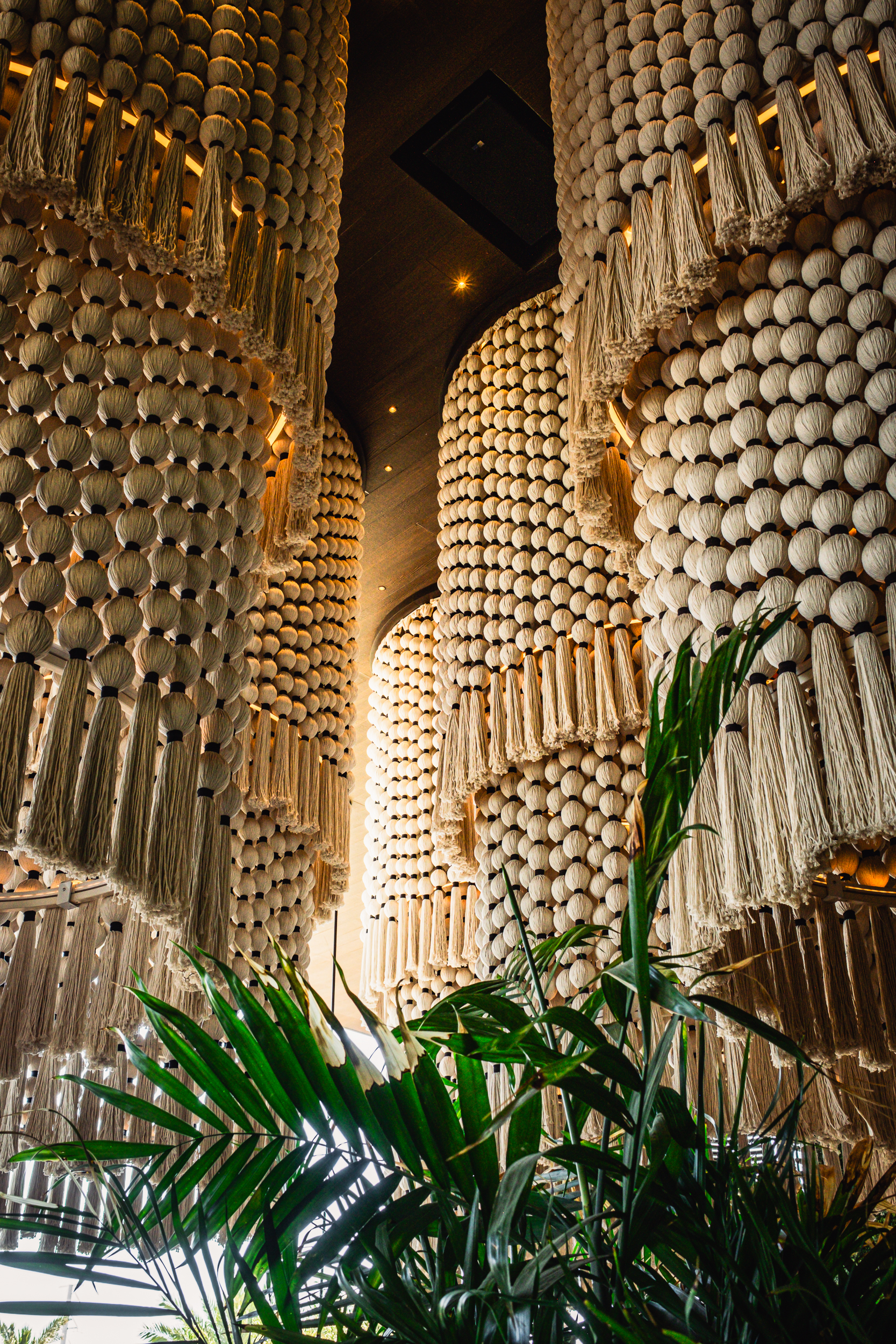 Signature macramé chandeliers and lush tropical décor inside Mijo Modern Mexican, a modern Mexican restaurant in Las Vegas offering elevated dining, Mexican brunch, and vibrant Summerlin hospitality.