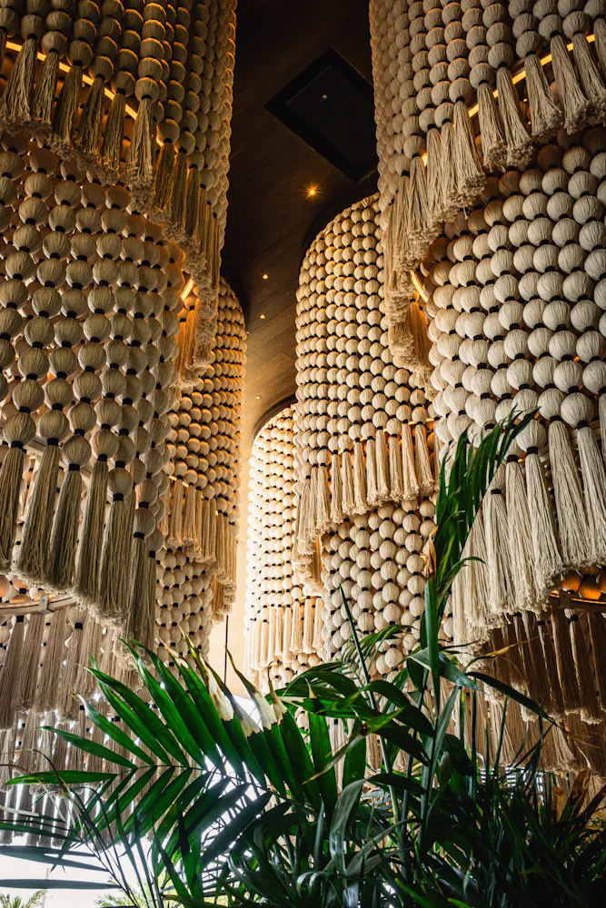 Signature macramé chandeliers and lush tropical décor inside Mijo Modern Mexican, a modern Mexican restaurant in Las Vegas offering elevated dining, Mexican brunch, and vibrant Summerlin hospitality.