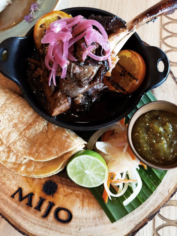 a photo of the Lamb Shank Barbacoa special at Mijo Modern Mexican served for Mexican Brunch