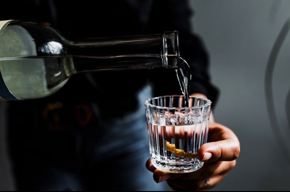 a photo of someone pouring water into a glass