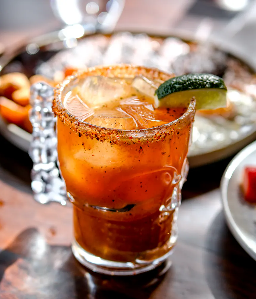 Refreshing michelada served with a Tajín rim and fresh lime at Mijo Modern Mexican, a Vegas Mexican restaurant known for Mexican brunch, handcrafted cocktails, and the best margarita in Las Vegas.