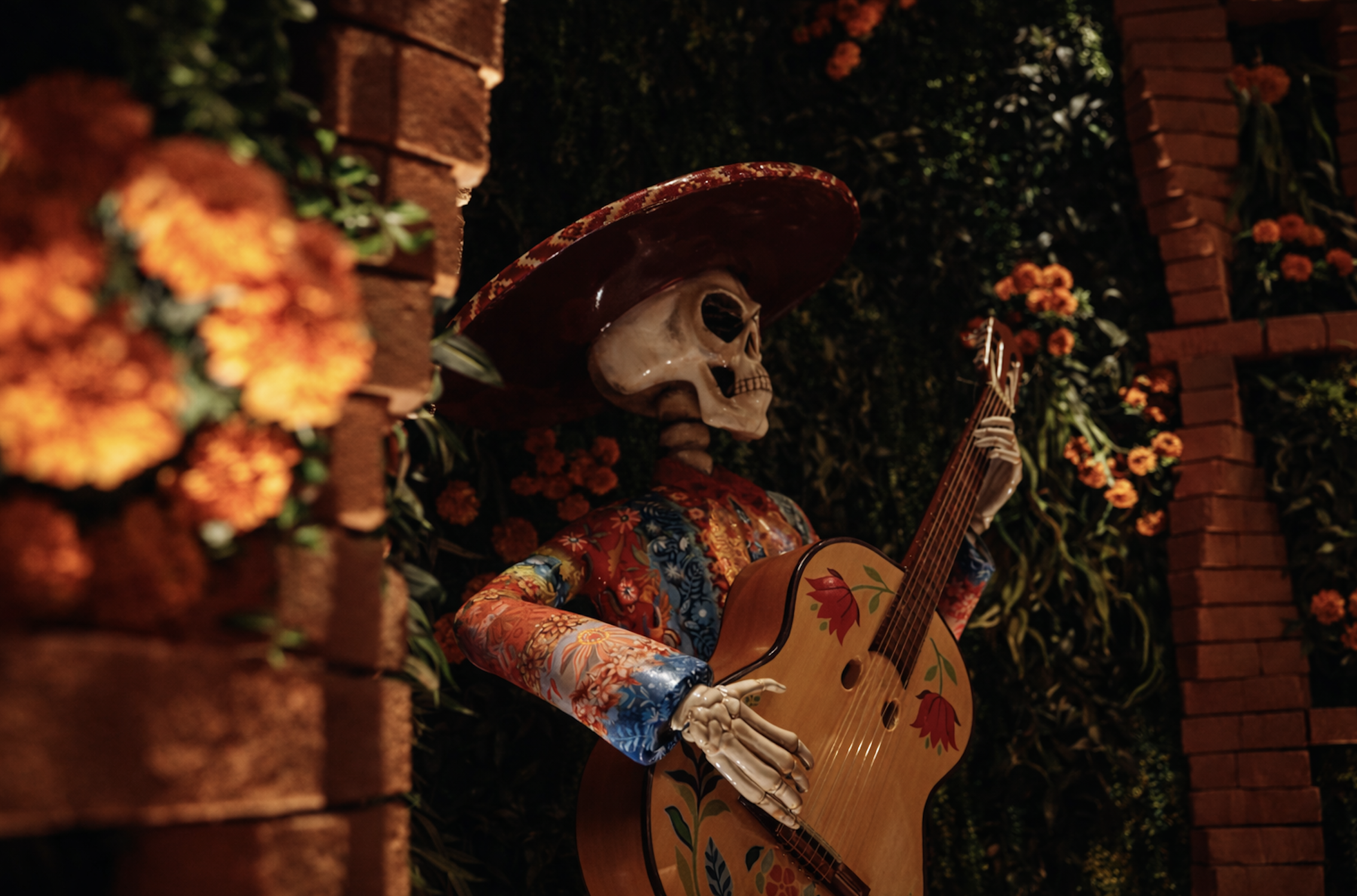 Traditional Día de los Muertos skeleton guitarist at Mijo Modern Mexican, a Vegas Mexican restaurant near Summerlin with vibrant décor, Mexican brunch, and handcrafted cocktails.