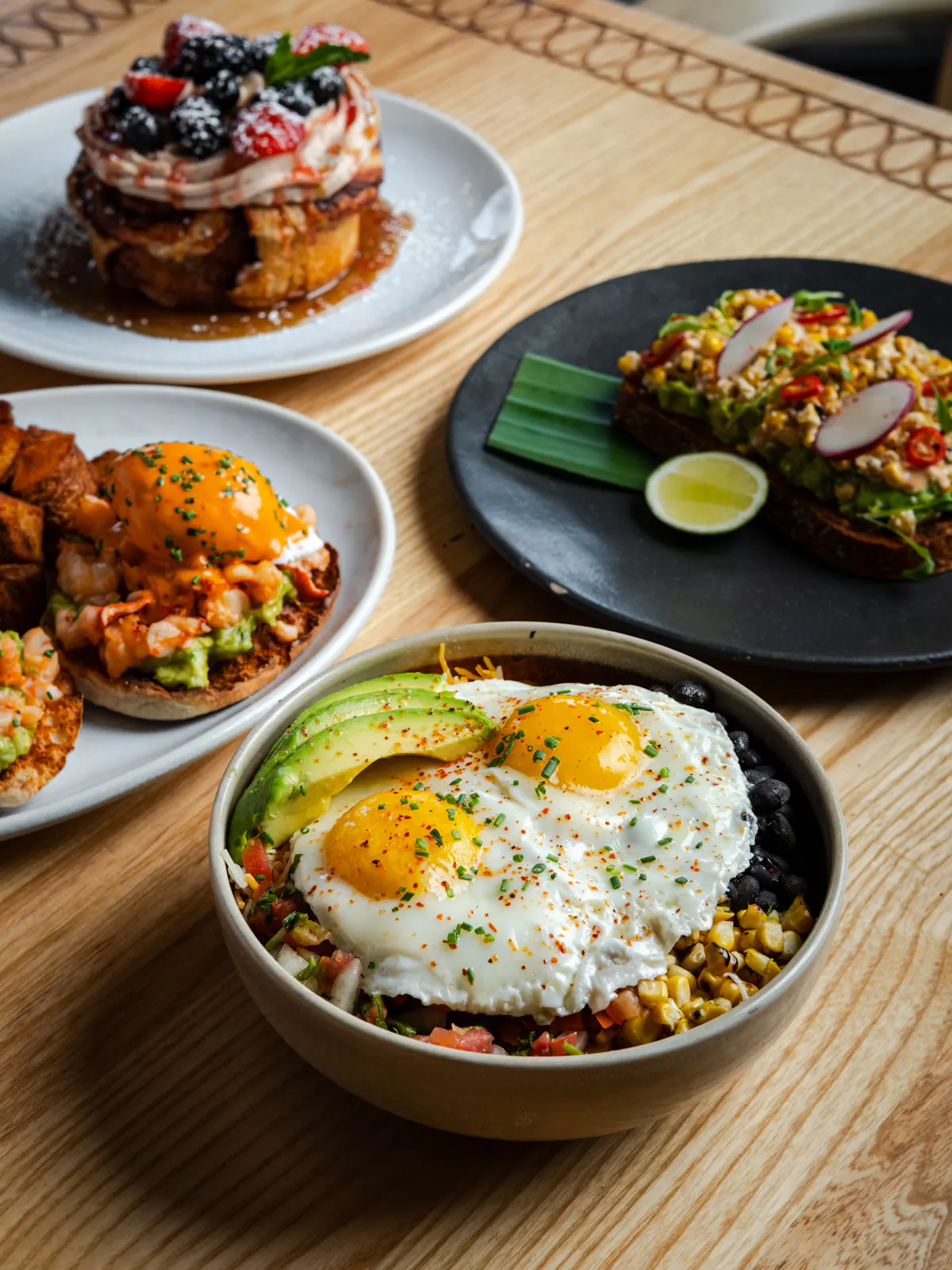 Colorful Mexican brunch spread featuring a protein bowl, lobster Benedict, avocado toast, and stuffed French toast at Mijo Modern Mexican, a Mexican restaurant in Las Vegas offering the best brunch near me and Summerlin brunch favorites.