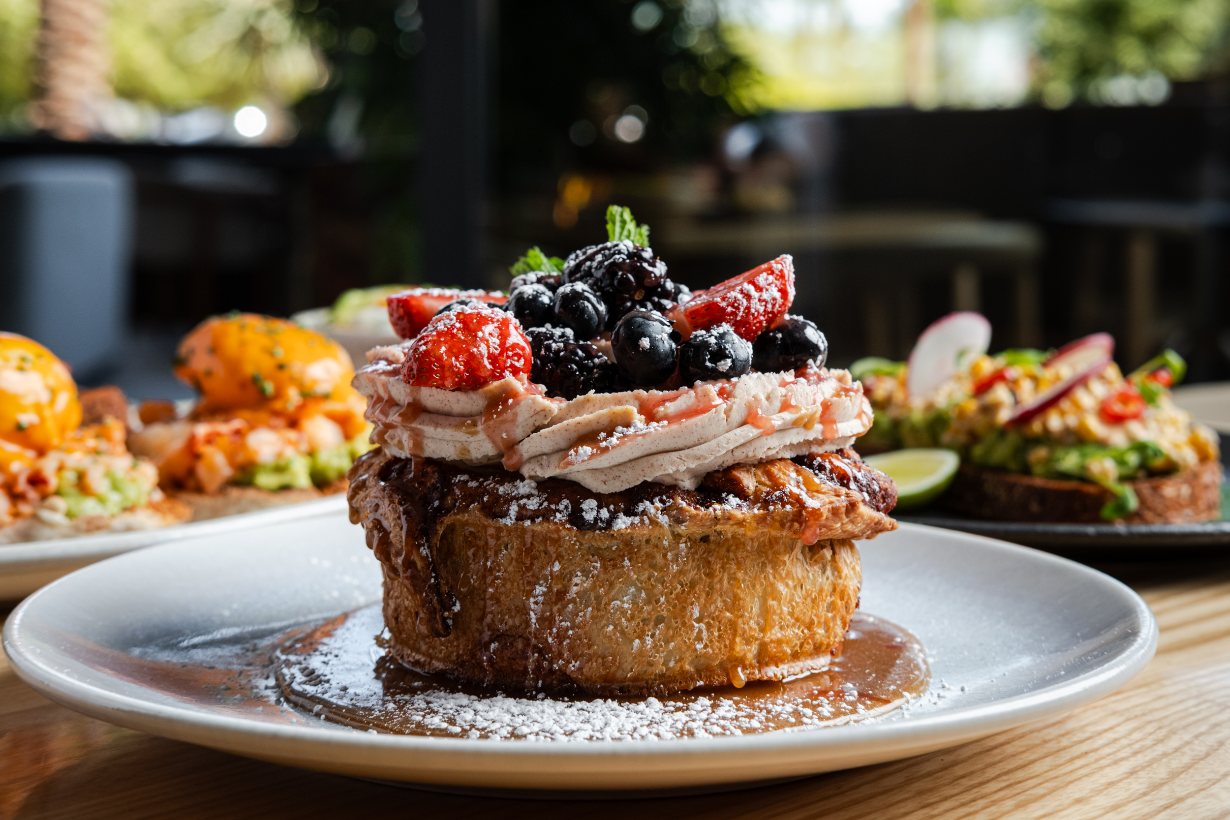 MIJO Sticky Cinnabun with horchata icing and fresh berries, featured on the new Summerlin brunch menu at Mijo Modern Mexican.