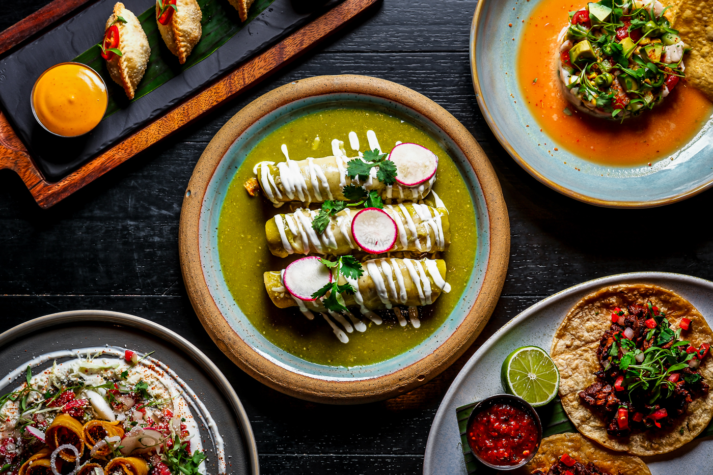 Colorful spread of modern Mexican dishes including tacos, enchiladas, ceviche, and appetizers served family-style at Mijo Modern Mexican brunch in Las Vegas.